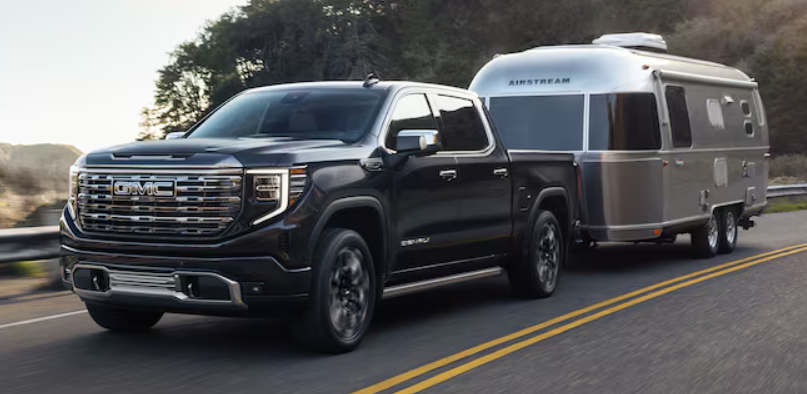 Black 2026 GMC Sierra 2500 towing a trailer