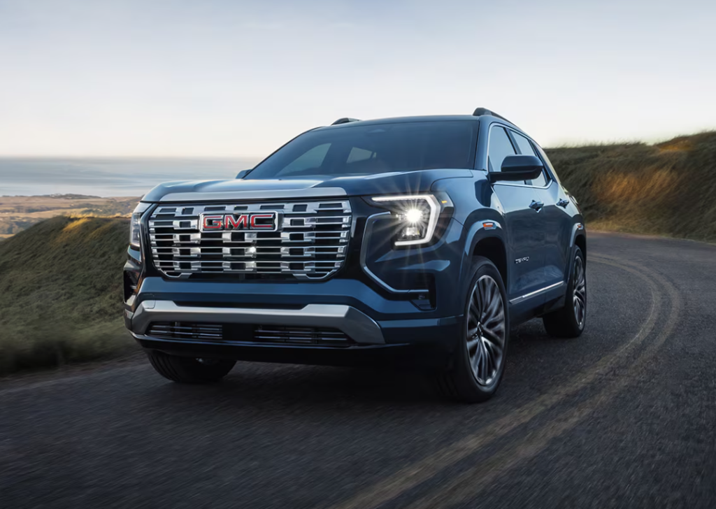 Blue 2026 GMC Terrain Denali driving on road