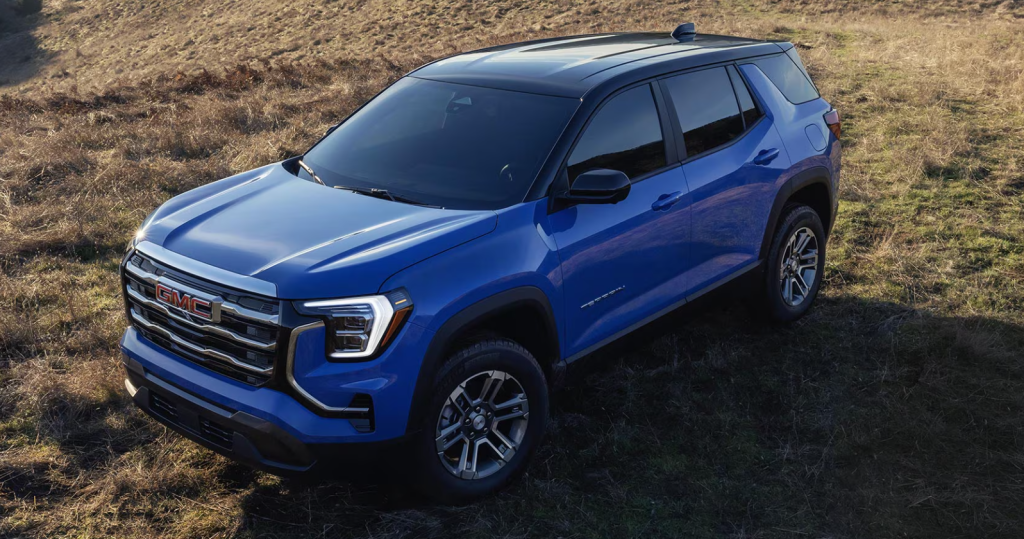 Blue 2026 GMC Terrain parked in grass