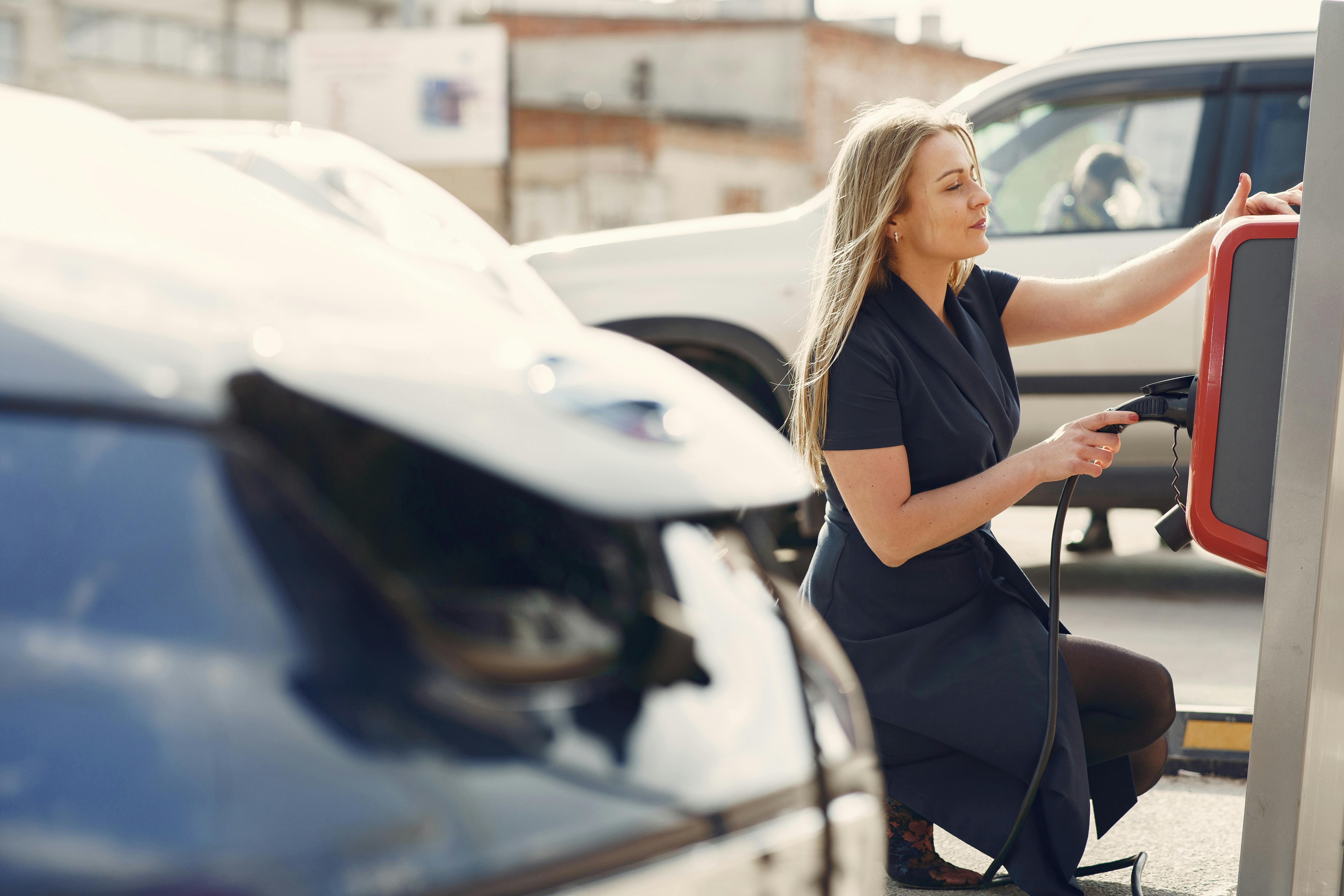 woman charging her electric vehicle