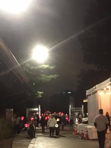 People walking at night holding glowing lanterns.
