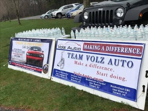Volz Auto sponsor banners displayed with water bottles.